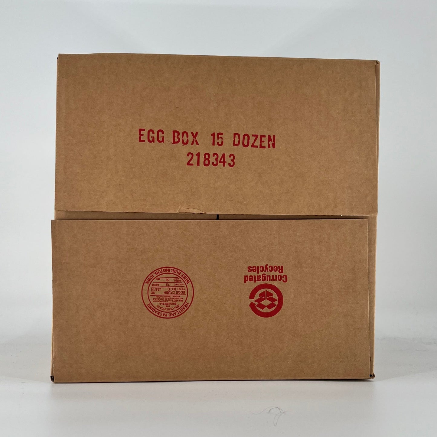 Brown cardboard egg box with red text on a white background