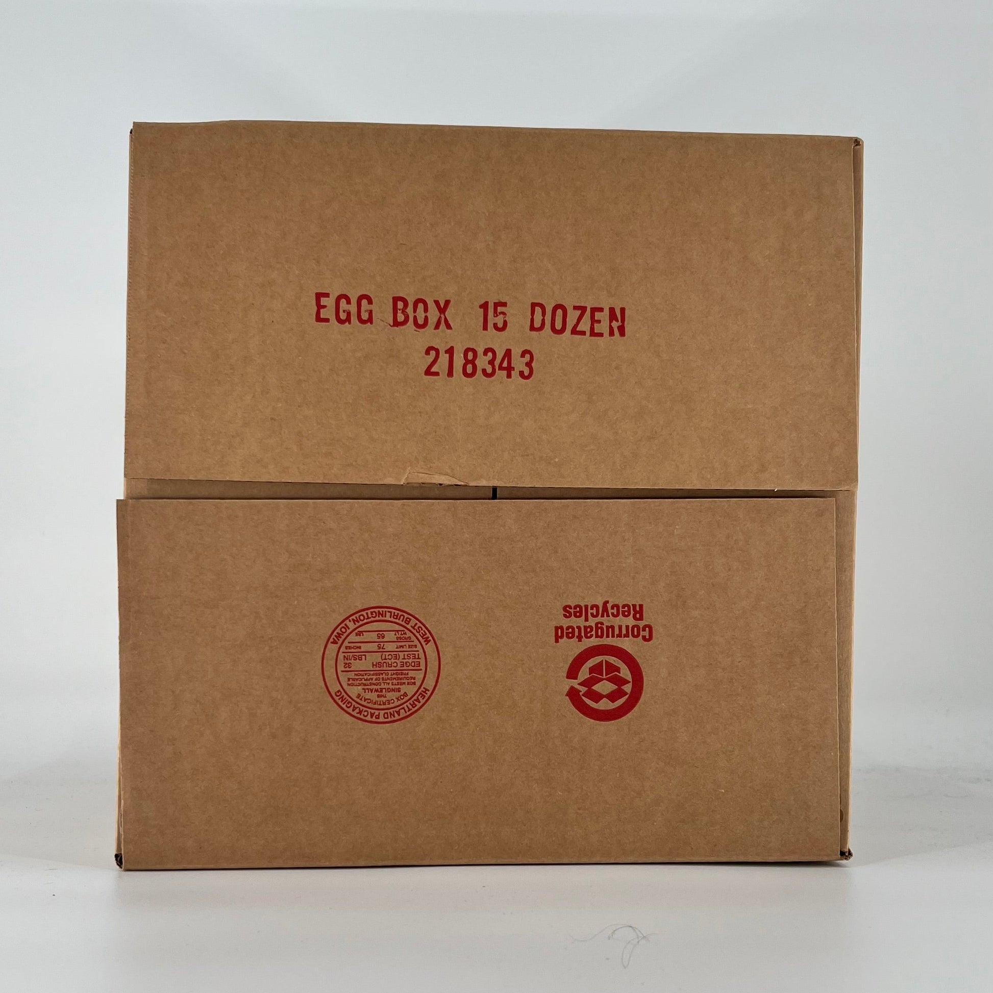 Brown cardboard egg box with red text on a white background